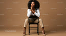 Fashionable Woman Sitting on Chair with Confident Pose in Studio