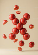 Floating red apples with halves on beige background