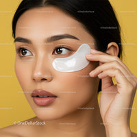 Close-up of a woman applying under-eye gel mask for skincare