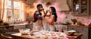 Couple Playfully Baking Heart-Shaped Cookies Together