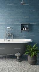 Classic clawfoot bathtub with blue tiled wall and plant
