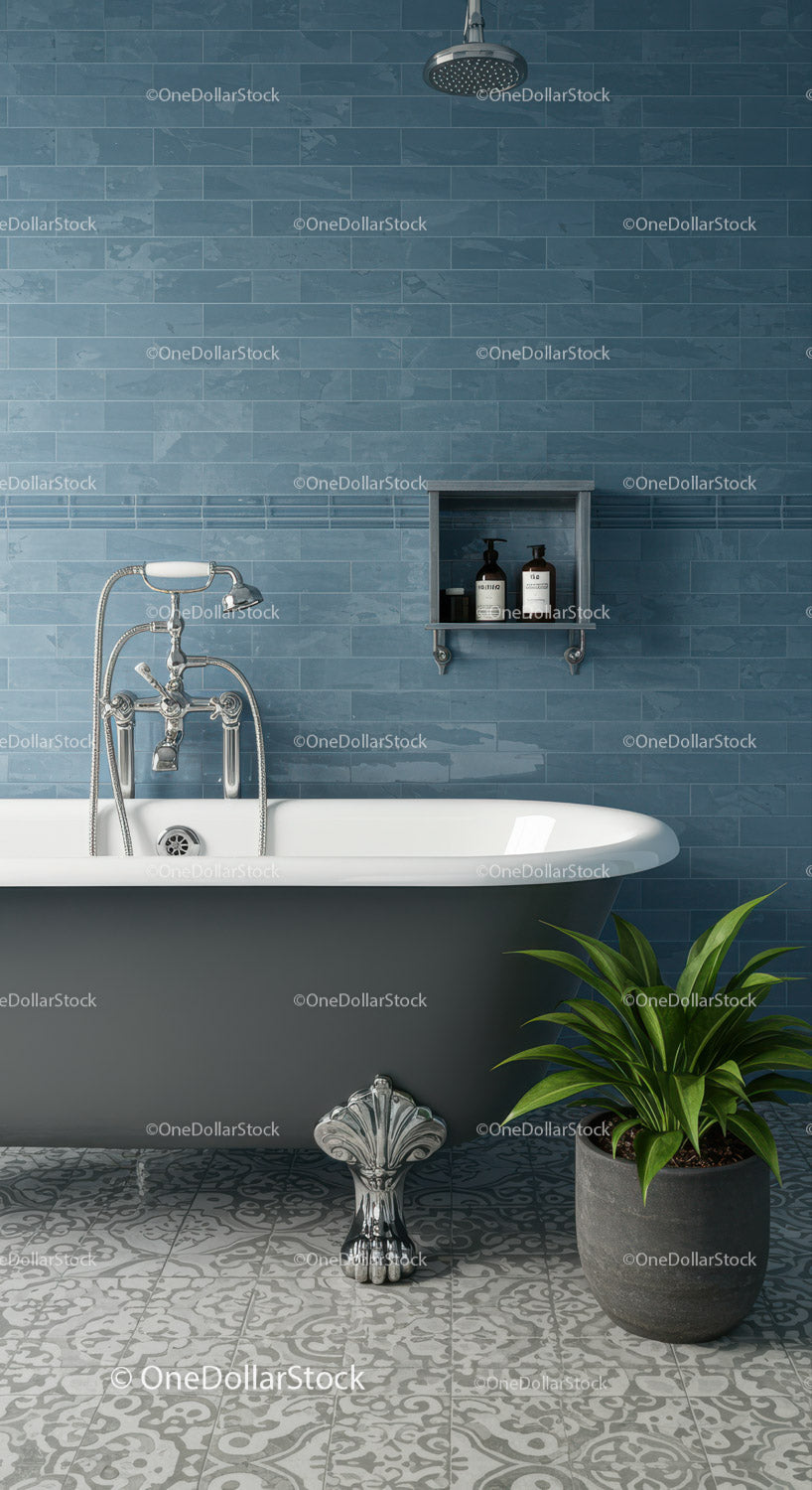 Classic clawfoot bathtub with blue tiled wall and plant