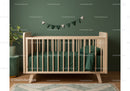 Modern Green Nursery with Wooden Crib and Houseplant