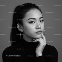 Elegant Black and White Portrait of a Confident Woman with Hoop Earrings