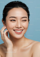 Portrait of a Smiling Young Woman with Clear Skin on Blue Background