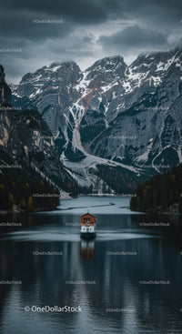 Serene Boat Journey on Alpine Lake with Snowy Peaks
