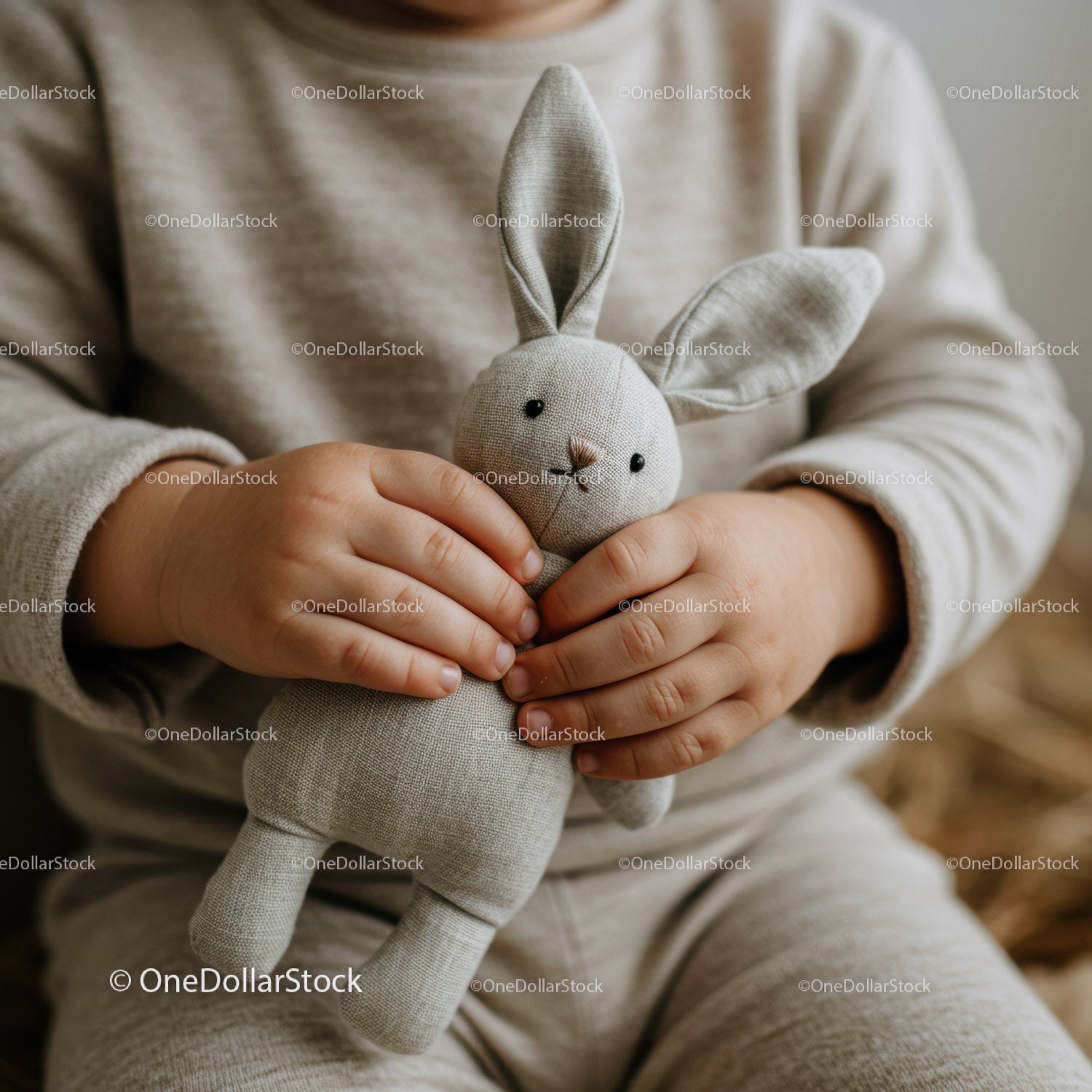 Child Holding Soft Fabric Bunny Toy with Care