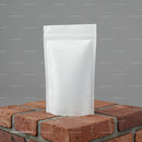 Blank White Stand-Up Pouch on Rustic Brick Surface