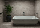 Modern beige tile bathroom with white freestanding bathtub and indoor plant