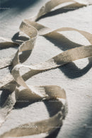Close-up of White Plastic Ribbon Waste on Sandy Beach