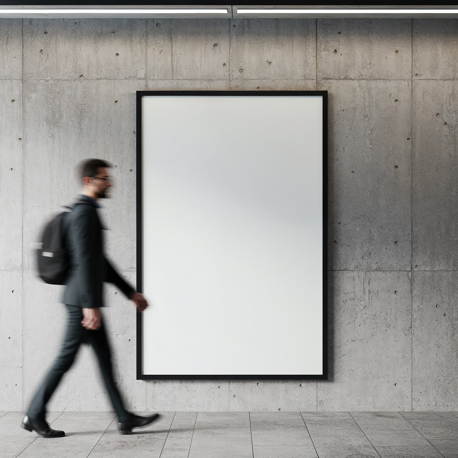 Man walking past blank poster on concrete wall interior