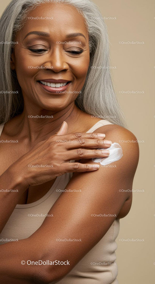 Elegant Senior Woman Smiling While Applying Lotion to Flawless Skin
