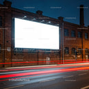 Illuminated Blank Billboard on Brick Building at Night