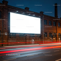 Illuminated Blank Billboard on Brick Building at Night