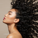 Profile of woman with flowing curly hair and closed eyes