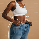 Woman Measuring Waist with Oversized Jeans for Body Transformation