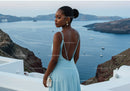 Elegant woman in blue dress overlooking sea view