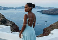 Elegant woman in blue dress overlooking sea view