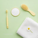 Yellow Bathroom Accessories with White Towel and Daisy