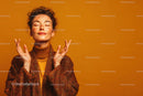 Freckled Woman with Peaceful Expression in Warm Studio Portrait