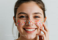 Joyful Woman with Colorful Sprinkles on Face Celebrating Happiness