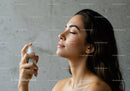 Woman Applying Hydrating Facial Mist for Skin Refreshment