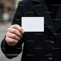 Person Holding Blank White Business Card Outdoors