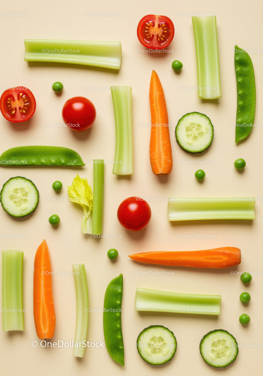 Fresh cut vegetables arranged on beige background