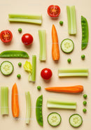 Fresh cut vegetables arranged on beige background
