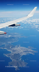 Aerial View of Mountain Landscape and Cloudscape from Airplane Window