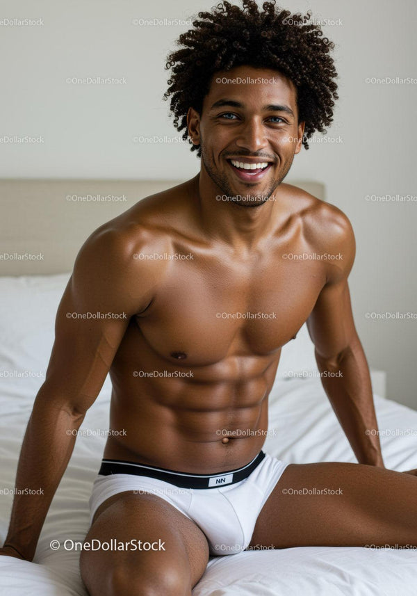 Smiling man with muscular build sitting on bed in white underwear