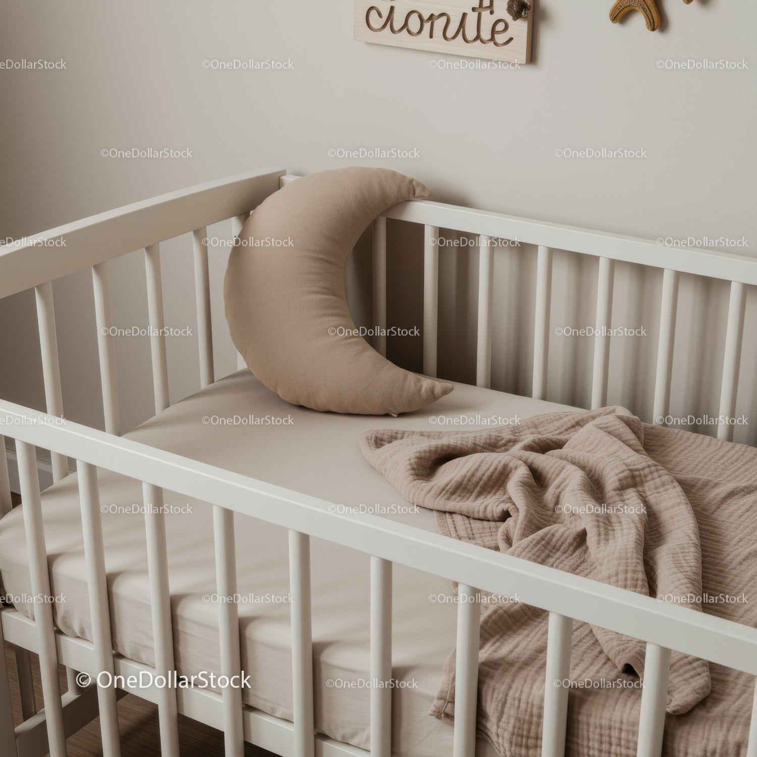 Minimalist baby crib with moon shaped pillow and blanket