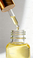 Close Up of Dropper with Golden Face Oil Serum