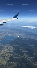 Aerial View of Mountainous Terrain and Lakes from Airplane Window