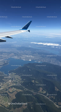 Aerial View of Mountainous Terrain and Lakes from Airplane Window