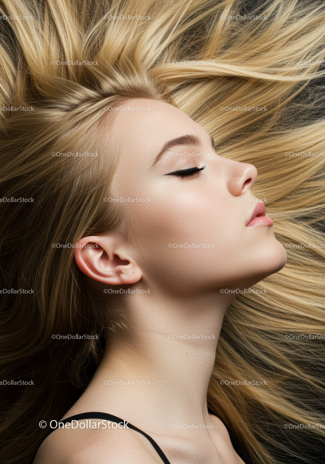 Blonde woman with flowing hair and serene expression