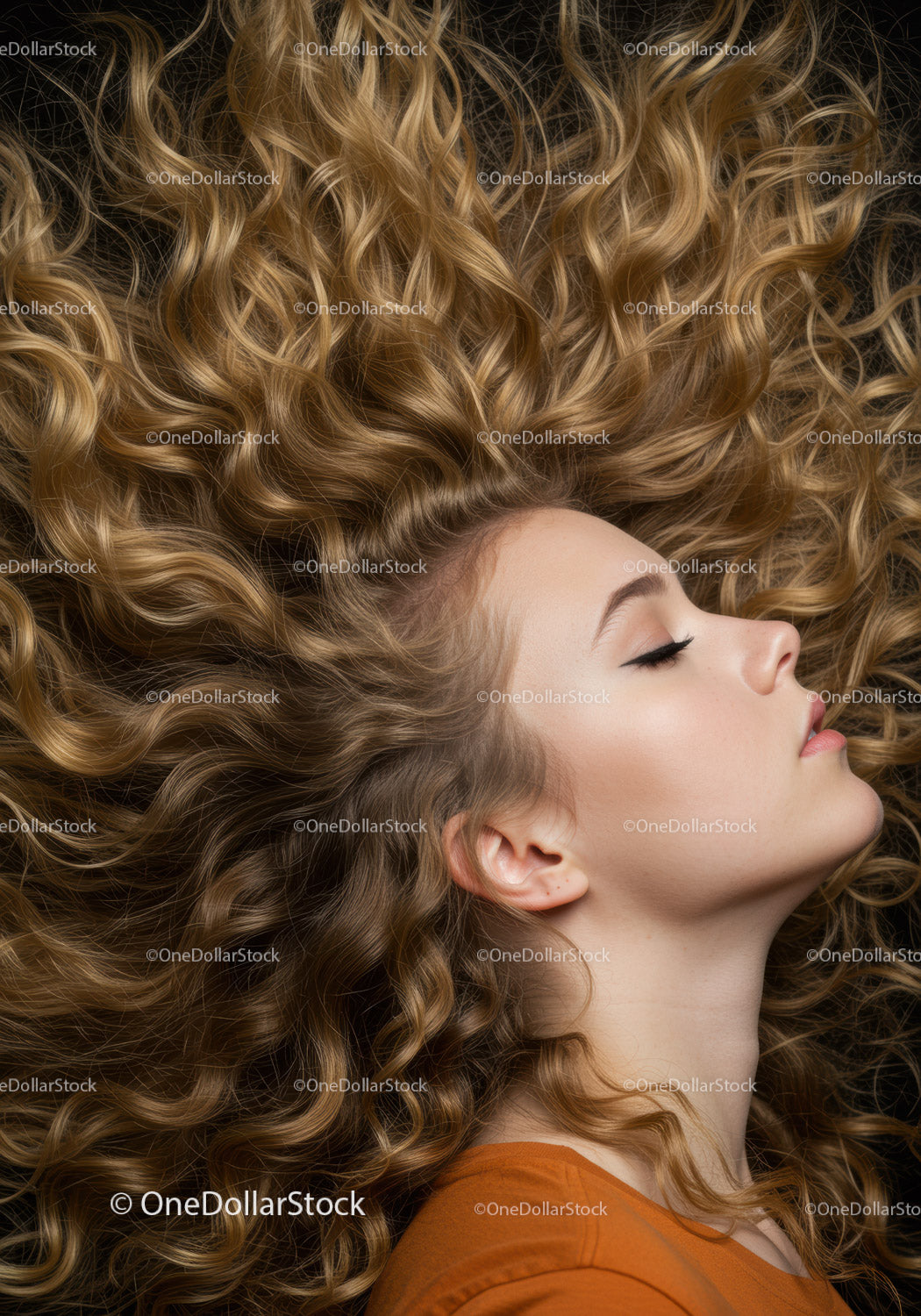 Profile of young woman with voluminous curly hair