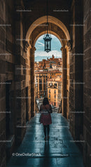 Historic Archway with Lantern Overlooking European Cityscape