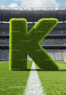Large Grass Letter K Standing on Football Field
