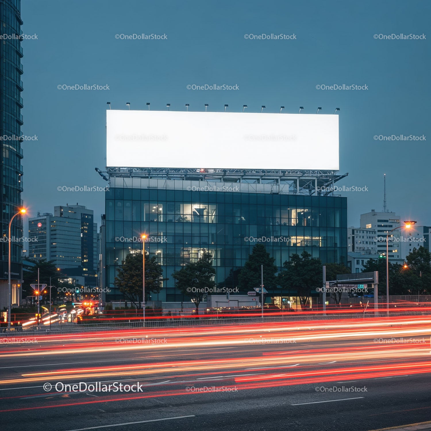 Modern cityscape with illuminated billboard at dusk