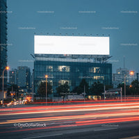 Modern cityscape with illuminated billboard at dusk