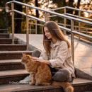Young woman enjoying time with her fluffy orange cat