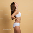 Fit Young Woman in White Sportswear Posing Against Beige Background