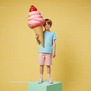 Young boy holding oversized strawberry ice cream cone