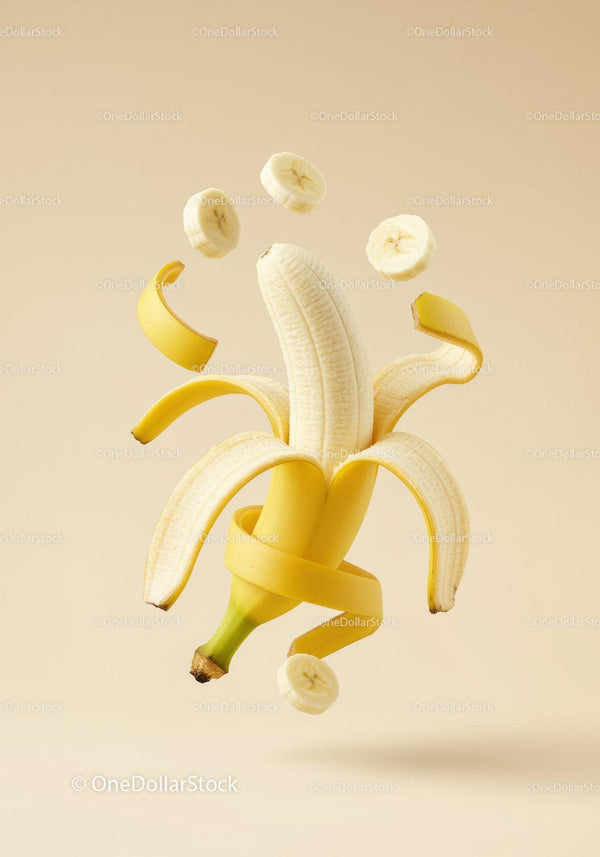 Creative peeled banana with floating slices and peel