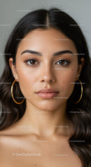 Elegant Close-Up of Brunette Woman with Brown Eyes and Hoop Earrings