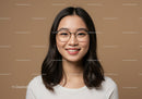 Portrait of a Happy Young Woman with Glasses on a Neutral Background