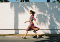Woman in Colorful Dress Walking Fast by Wall JPG Mockup Image preview