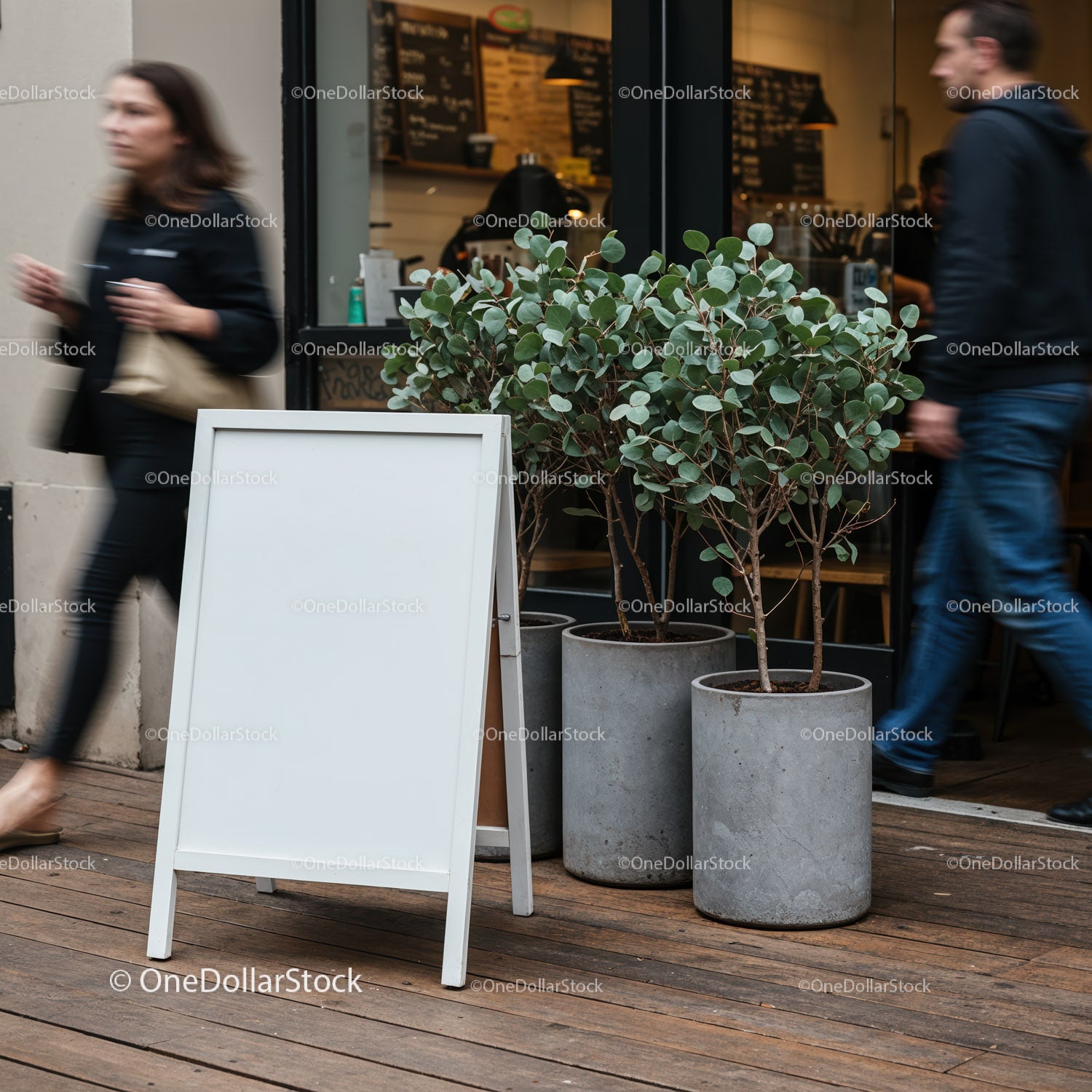 Blank sidewalk sign with plants outside urban cafe