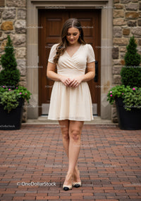 Elegant Woman Walking Outdoors in Summer Dress on City Street